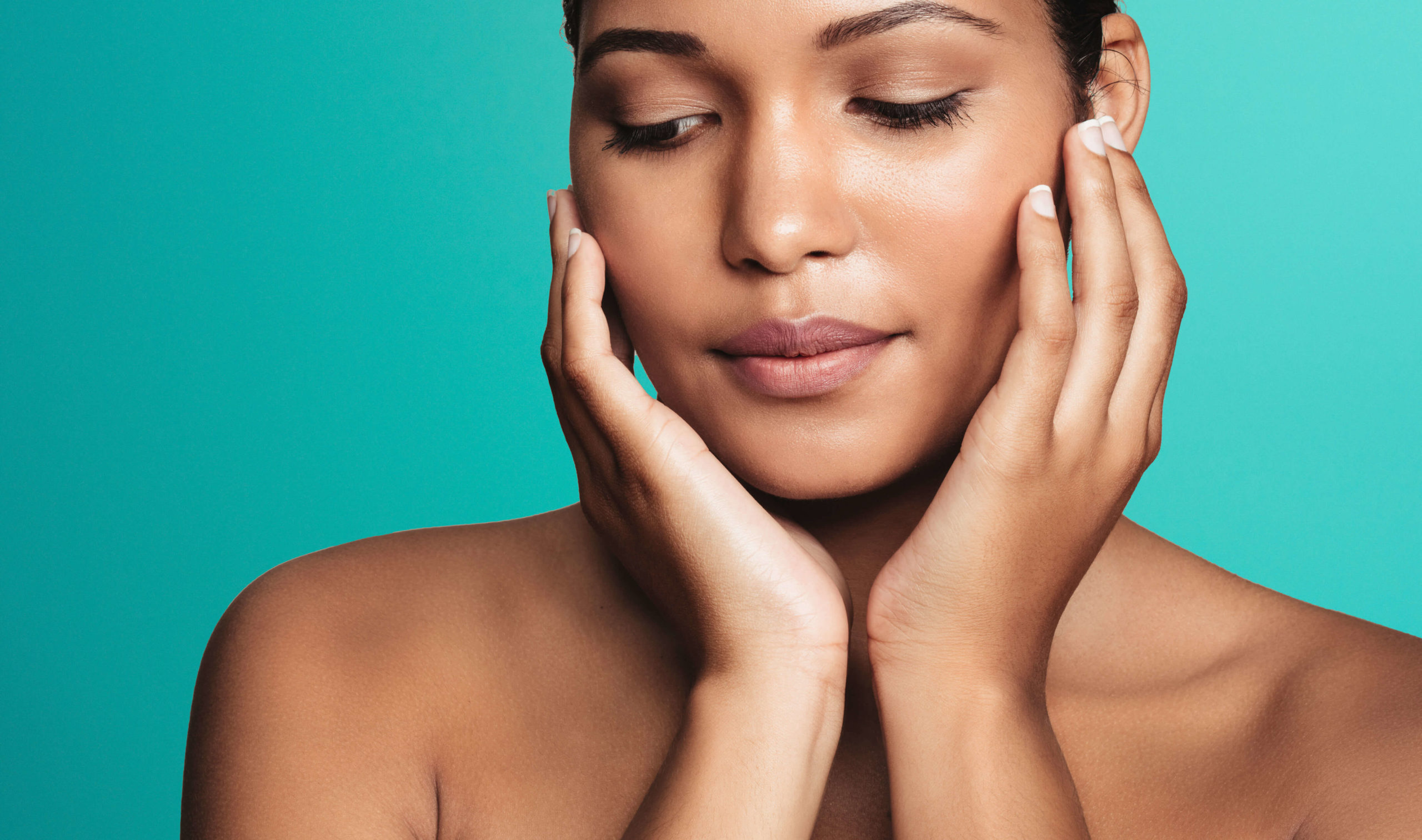 Close-up of a woman with eyes closed framing her face with both hands against for Sofwave ultrasound skin lifting in Dublin